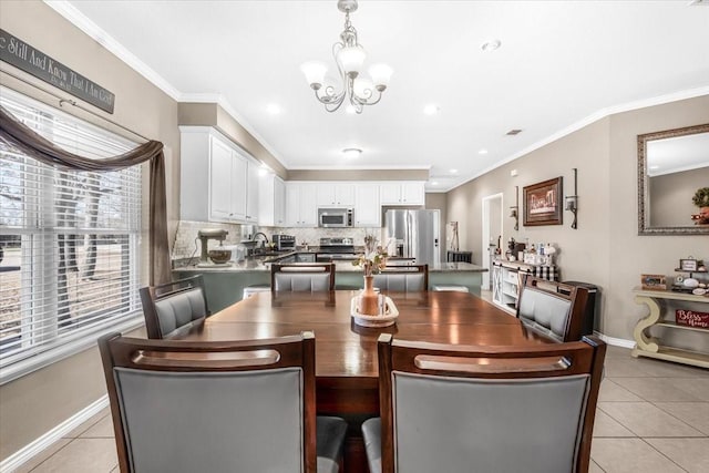 dining room with a notable chandelier, ornamental molding, and light tile patterned floors