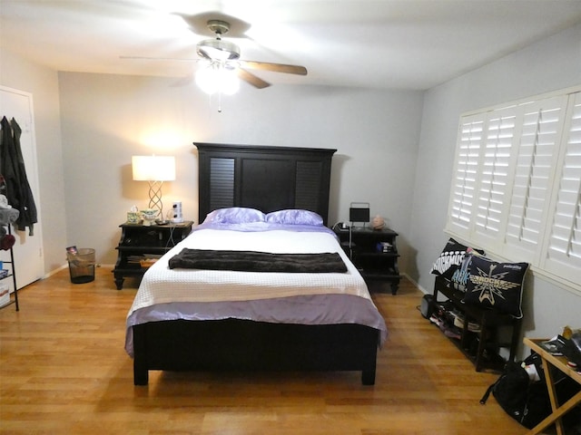 bedroom with wood-type flooring and ceiling fan