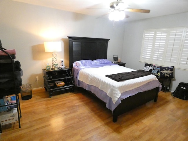 bedroom with light hardwood / wood-style floors and ceiling fan