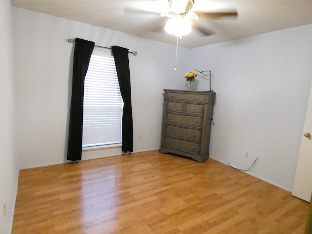 empty room with ceiling fan and light wood-type flooring