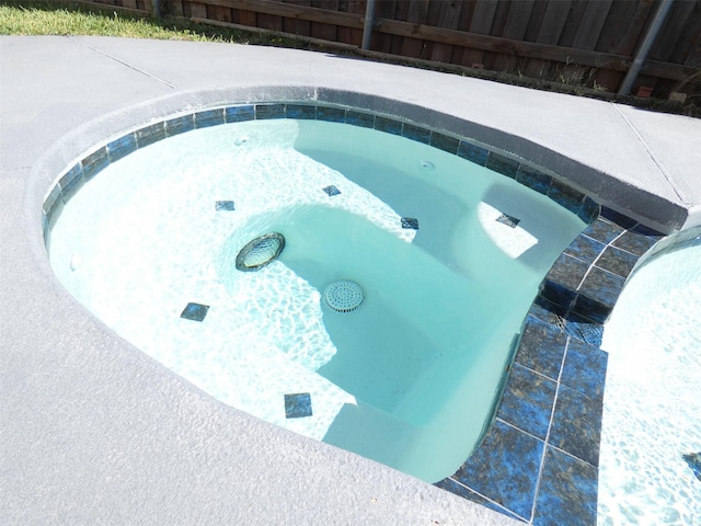 view of pool with an in ground hot tub