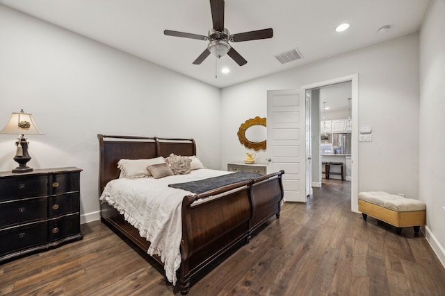 bedroom with stainless steel fridge, ceiling fan, and dark hardwood / wood-style flooring