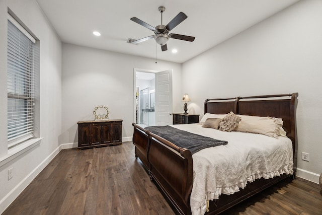 bedroom with dark wood-type flooring, connected bathroom, and ceiling fan