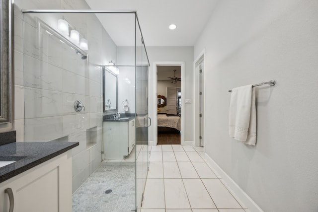 bathroom featuring tile patterned flooring, walk in shower, ceiling fan, and vanity