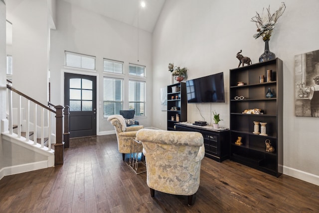 living room with dark hardwood / wood-style floors and high vaulted ceiling