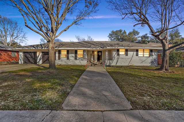 single story home with a garage and a lawn