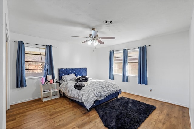 bedroom with ceiling fan and hardwood / wood-style flooring