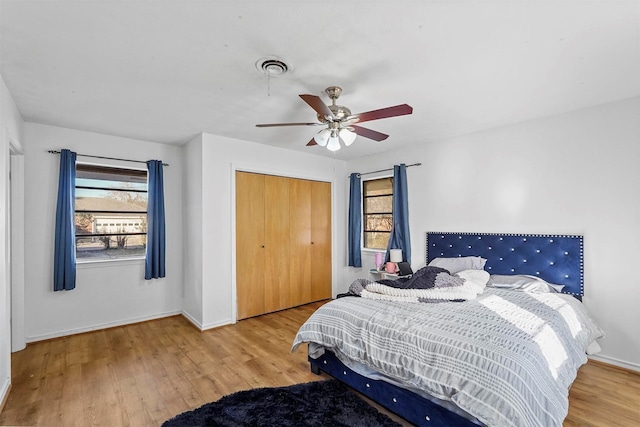 bedroom featuring ceiling fan, hardwood / wood-style floors, and a closet