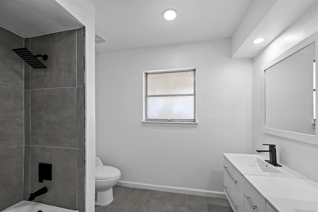 full bathroom featuring toilet, vanity, tiled shower / bath combo, and tile patterned flooring