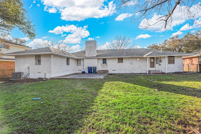 back of house with cooling unit, a patio area, and a yard