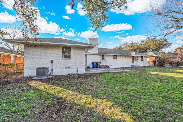 back of house featuring a patio area, a lawn, and central AC