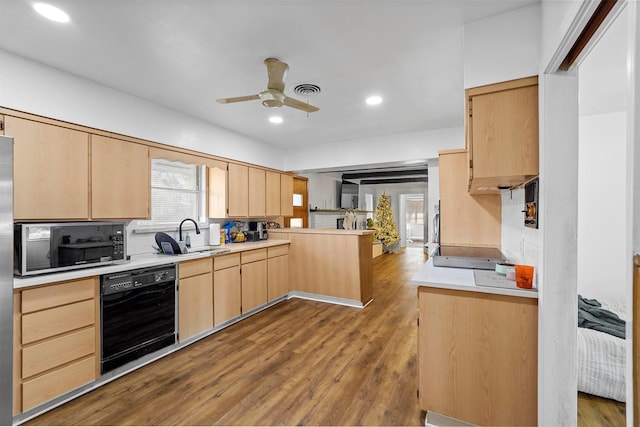 kitchen featuring black appliances, light brown cabinets, sink, kitchen peninsula, and hardwood / wood-style flooring