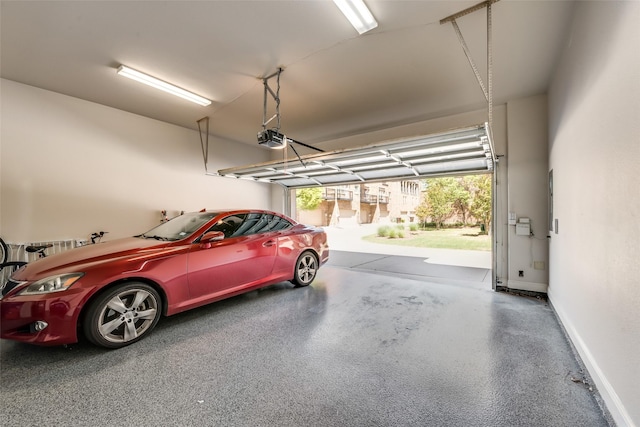 garage featuring a garage door opener and a carport