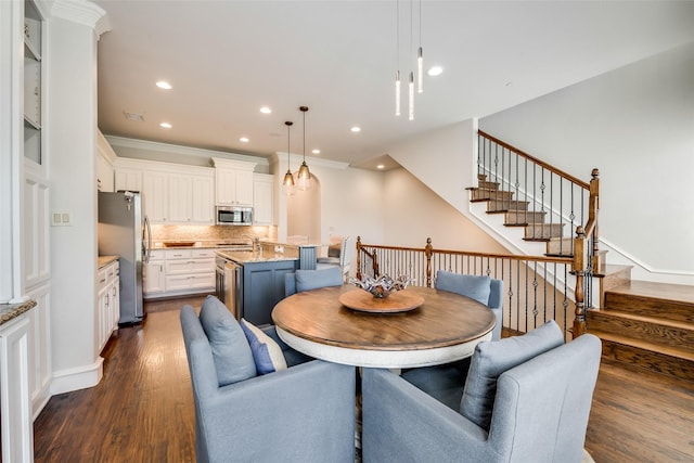 dining space with crown molding and dark hardwood / wood-style flooring