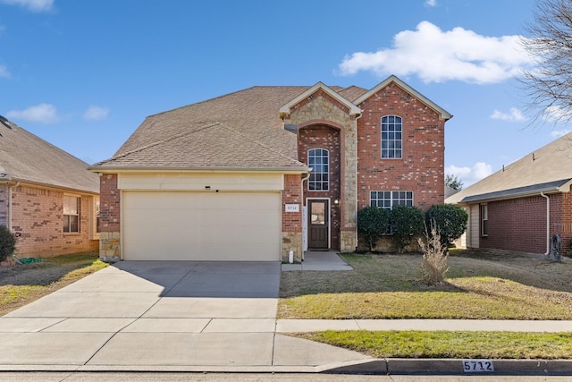 front of property featuring a garage and a front lawn