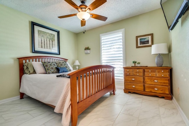 bedroom featuring ceiling fan and a textured ceiling