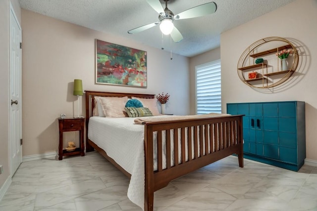 bedroom featuring ceiling fan and a textured ceiling