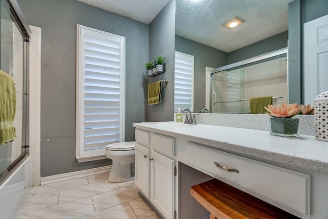 full bathroom with toilet, a textured ceiling, combined bath / shower with glass door, and vanity