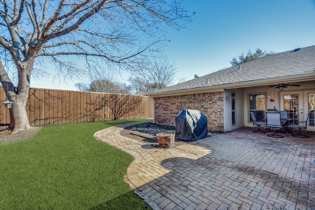 view of yard featuring a patio area and ceiling fan