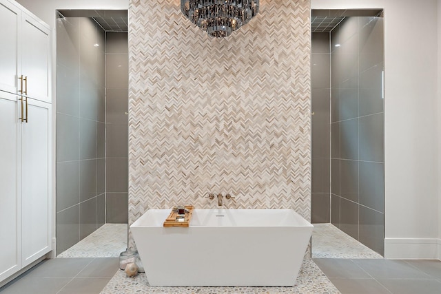 bathroom with tile walls, tile patterned floors, and shower with separate bathtub