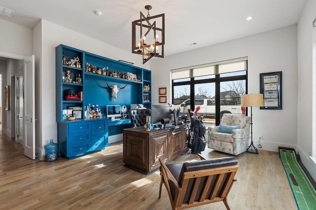 office space with a chandelier and light hardwood / wood-style flooring