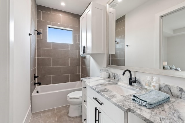 full bathroom featuring vanity, toilet, tile patterned floors, and tiled shower / bath combo