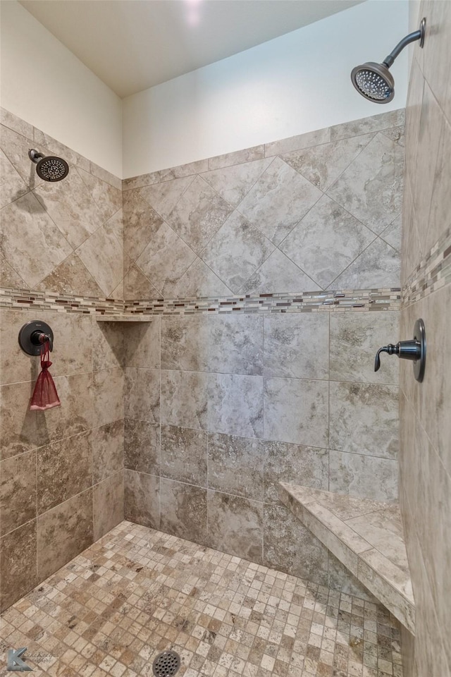 bathroom with tiled shower