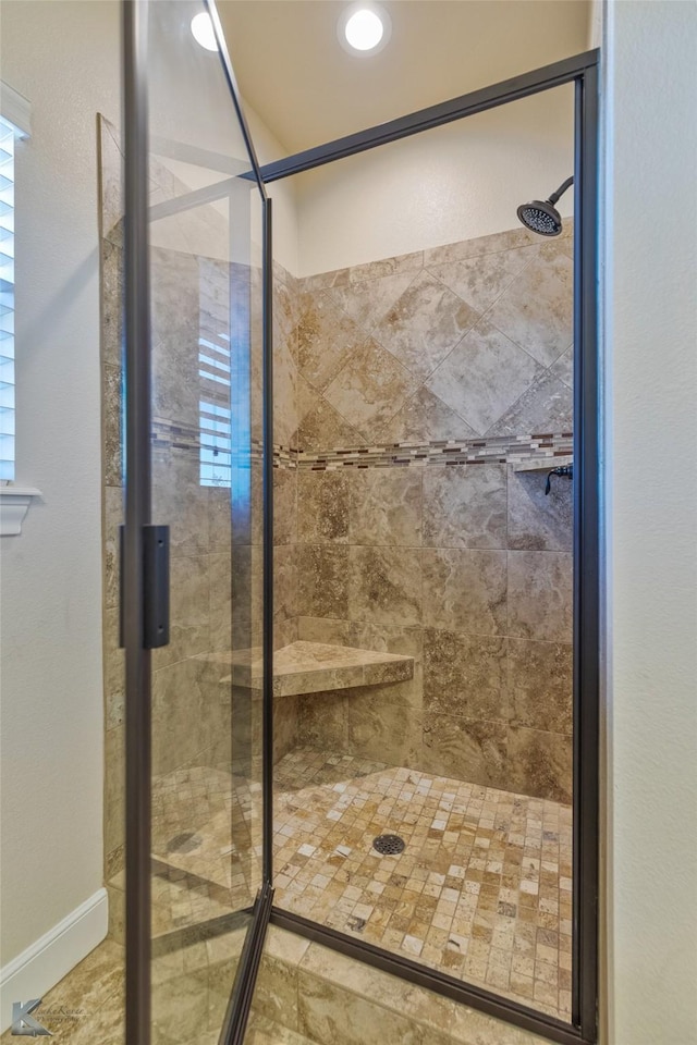 bathroom with a shower with door