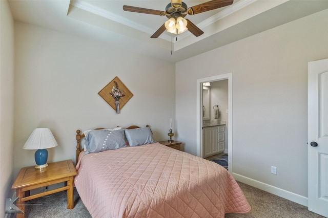 bedroom featuring carpet flooring, ornamental molding, ceiling fan, a raised ceiling, and ensuite bath