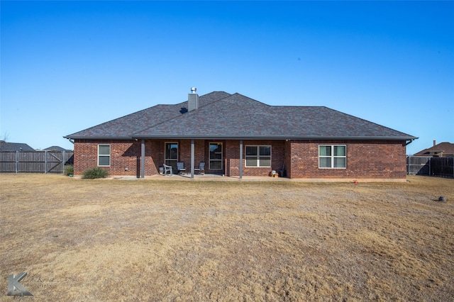 back of house featuring a yard and a patio area