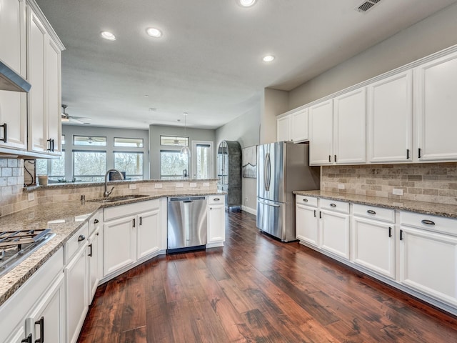 kitchen featuring white cabinetry, sink, light stone counters, and stainless steel appliances