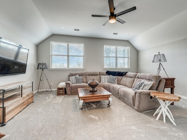 living room with ceiling fan, lofted ceiling, and light carpet