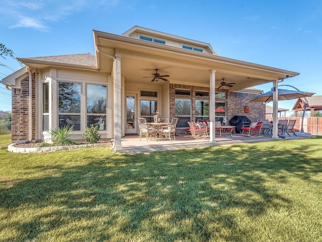 rear view of house with a yard, ceiling fan, and a patio area