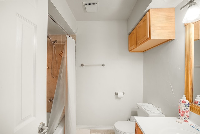 full bathroom featuring vanity, shower / bath combo with shower curtain, and toilet