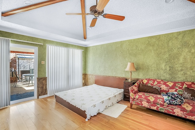 bedroom featuring wood-type flooring, vaulted ceiling, access to outside, ornamental molding, and ceiling fan