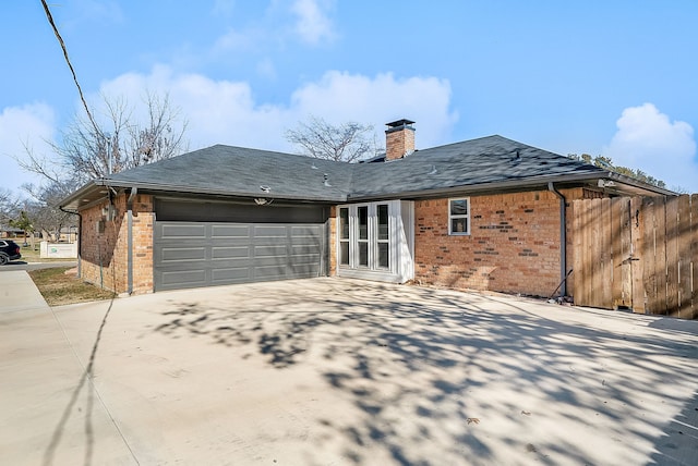 rear view of property with a garage