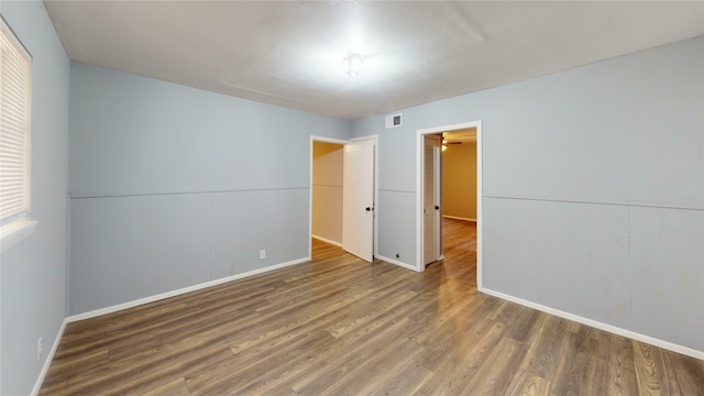 empty room with wood-type flooring