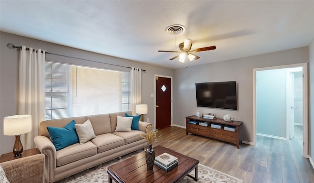 living room featuring hardwood / wood-style flooring and ceiling fan