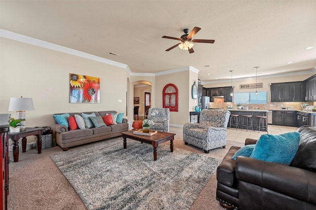 living room featuring crown molding, light colored carpet, and ceiling fan