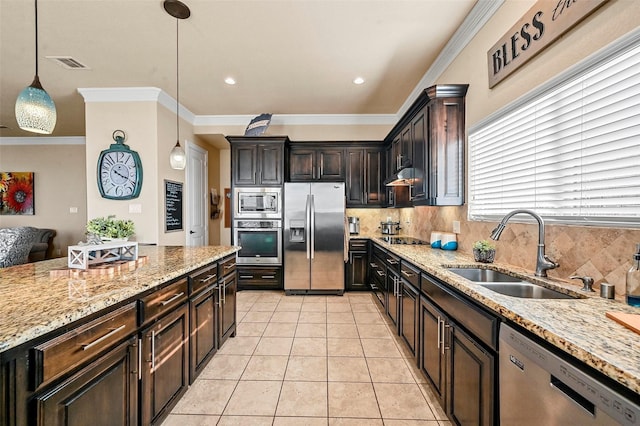 kitchen with light tile patterned flooring, sink, decorative light fixtures, dark brown cabinets, and appliances with stainless steel finishes