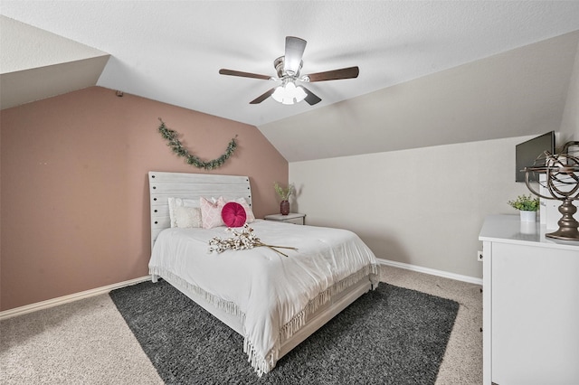 bedroom featuring a textured ceiling, vaulted ceiling, ceiling fan, and carpet