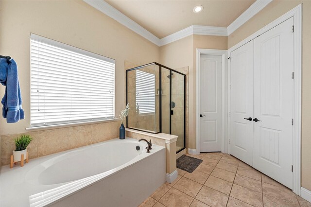 bathroom with a shower with door, vanity, tile patterned floors, and crown molding