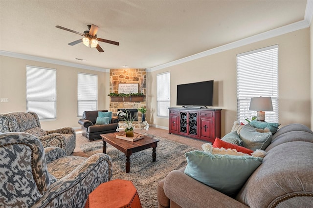 living room with ornamental molding, carpet floors, ceiling fan, and a fireplace