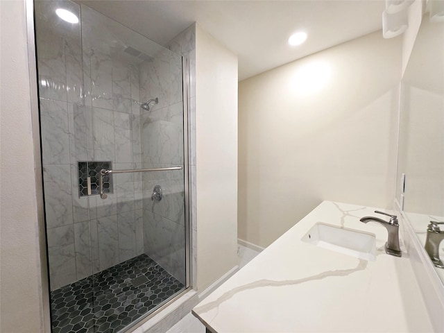 bathroom with vanity and a shower with door