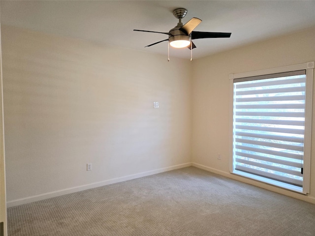 unfurnished room featuring ceiling fan and light carpet