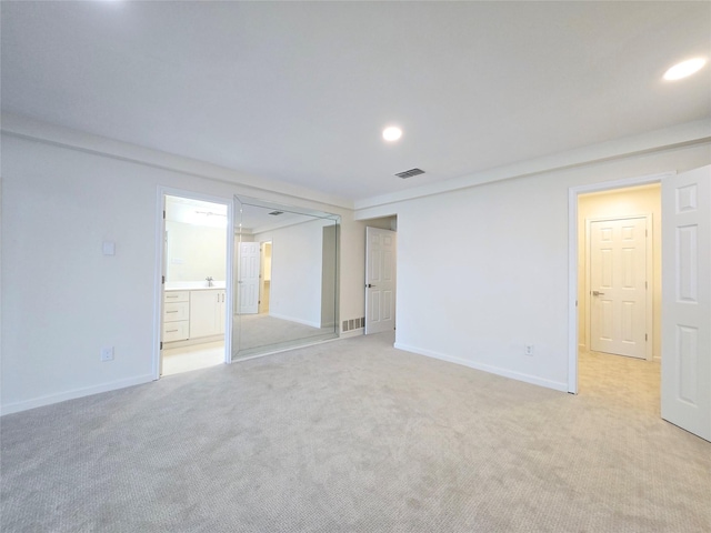 unfurnished room with light carpet