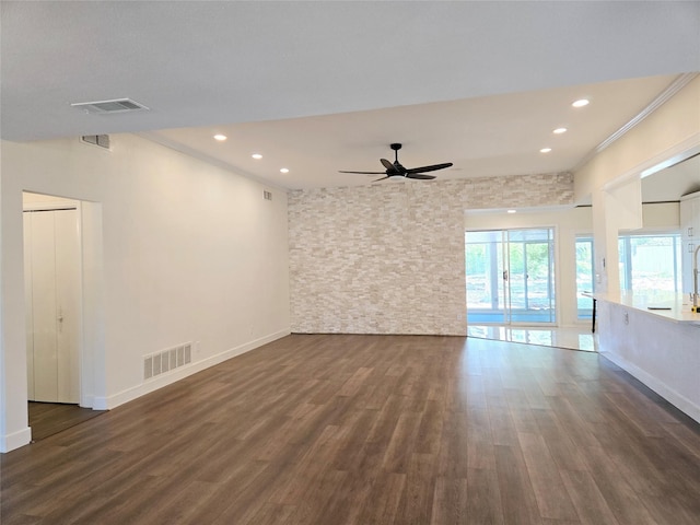 unfurnished room with ceiling fan, dark hardwood / wood-style flooring, and ornamental molding