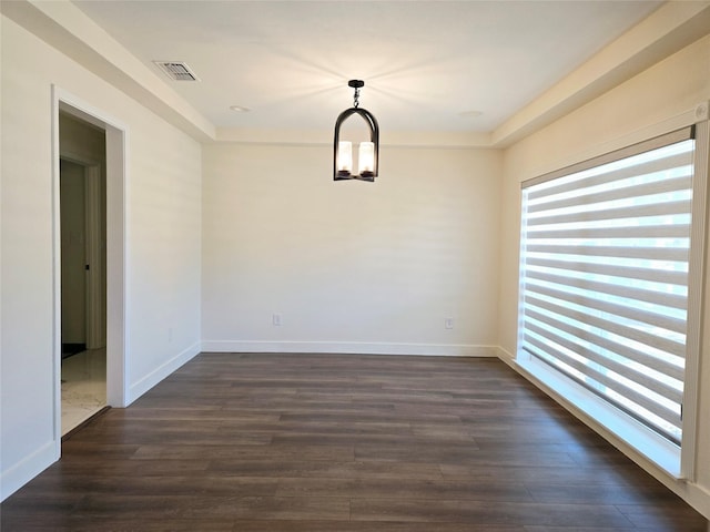 unfurnished dining area featuring dark wood-type flooring and a chandelier