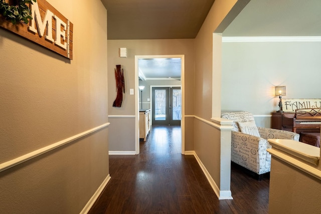 hallway featuring french doors, crown molding, and dark hardwood / wood-style flooring