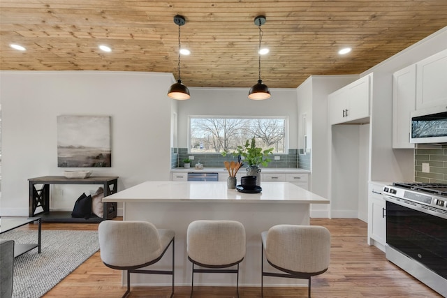 kitchen featuring a center island, hanging light fixtures, wooden ceiling, stainless steel appliances, and white cabinets